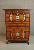 A Korean hardwood bandaji cabinet, with three short drawers over a pair of cupboard doors, above