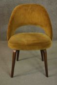 A mid 20th century style side chair, with a curved back and upholstered in mustard coloured