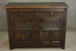 A country antique oak style sideboard fitted with carved drawers and drawers on block supports. H.91