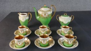 A Japanese Samurai China six person coffee set with green ground and gilt decoration. Maker's