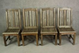 A set of four contemporary Barlow and Tyrie teak garden dining chairs, with slatted seats.