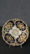 A 19th century Meissen porcelain gilt highlighted cobalt blue dish decorated with flowers in relief.