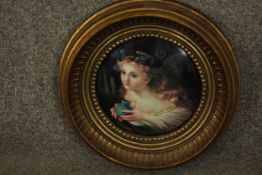 A round gilt framed ceramic plaque of a fairy. Makers mark verso. Dia.29cm.