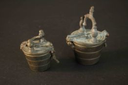 Two sets of 19th century bronze apothecary weights in the form of buckets with hinged lids and