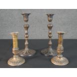 Two pairs of 19th century repousse design candle sticks. H.29 Diam.14cm (largest)