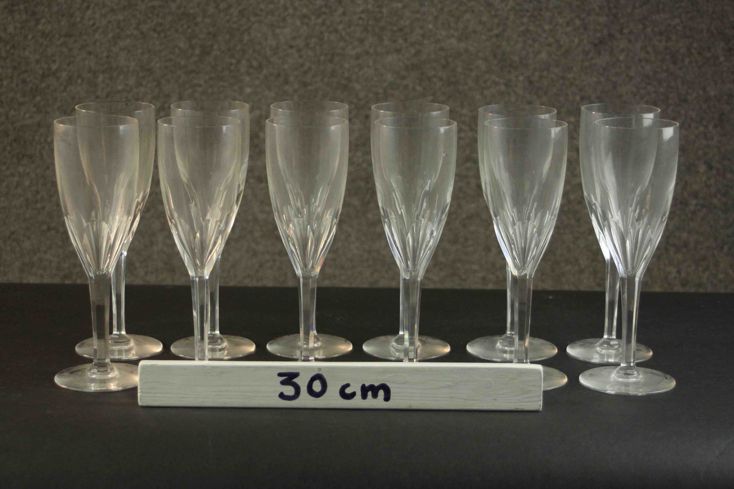 A set of twelve hand cut Baccarat crystal petal faceted champagne flutes, etched maker's stamp to - Image 2 of 4