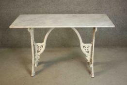 A 19th century white painted cast iron table, with a rectangular white marble top, the base with