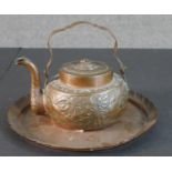 An Arts and Crafts repousse design copper tea pot with animals and foliate design along with a