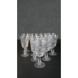A collection of twelve hand cut Stuart crystal wine glasses with star cut bases. Maker's stamp to