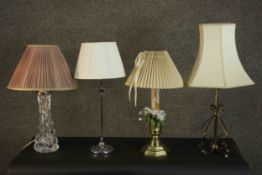 A collection of four table lamps with shades, including one formed from a brass candlestick, a