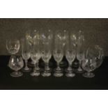 A collection of hand cut glass and crystal drinking glasses, including a set of six champagne