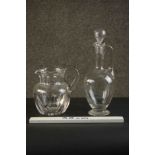 A hand cut Baccarat crystal Harcourt pitcher along with a hand blown handled glass decanter and