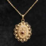 9ct gold Garnet and Seed Pearl locket pendant and chain, 9.4 grams. Chain 55 cm, locket 4.5 cm. UK
