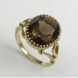 9ct gold and Smokey Quartz single stone ring, London 1977, 4.3 grams. Size L, 13.6 mm. UK Postage £