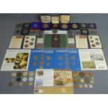 Commemorative medallions and coins, including a 1910-1935 George V medallion and cased coin sets.