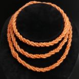 Pink coral bead twisted strand flapper length necklace, circa 1900, 85 grams. 118 cm.