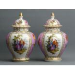 A pair of hand painted Dresden porcelain Temple Jars and covers. 23 cm high. UK Postage £20.
