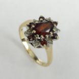 9ct gold Garnet and Diamond ring, London 1977, 2.5 grams. Size J, 12.2 mm wide. UK Postage £12.