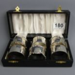 Six boxed George V silver napkin rings, Sheffield 1914 and 1918, 193 grams. UK Postage £12.