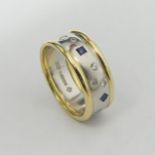 Platinum and 18ct gold Sapphire and Diamond ring, London 2000, 13.8 grams. Size S, 8.9 mm wide. UK