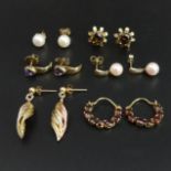 A pair of 9 carat gold smokey quartz earrings, a pearl set pair and four other pairs of gold