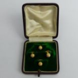 A set of four 18 carat gold dress studs/buttons, 4.4 grams. UK Postage £12.