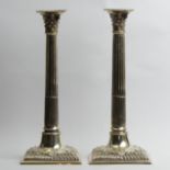 A pair of George III silver Corinthian candlesticks one London 1763 the other apparently un-