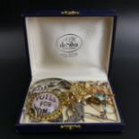 A box of mixed jewellery, including silver rings, a horse brooch, suffragette brooch and a charm