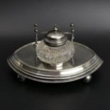 Victorian silver plate and glass inkwell on a plated stand. 16 cm wide. UK Postage £12.