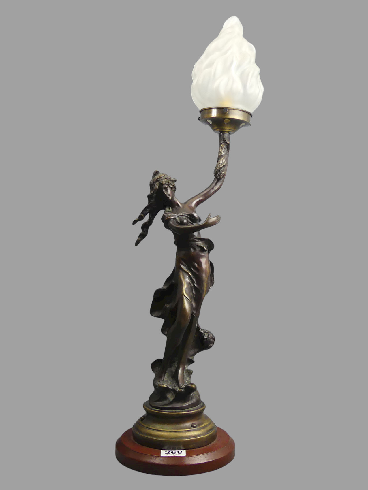 Bronze Art Nouveau style figural lamp with a glass flame shade. 75 cm. UK Postage £30.