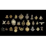 A collection of un-collated military cap badges (26). UK Postage £12.