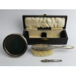 Silver photo frame, William Comyns, London 1899, silver hairbrush case and a silver Sampson and