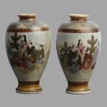 A pair of early 20th century Japanese Satsuma pottery vases with lake and figure scenes. 22 cm. UK