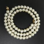 A cultured pearl 42 cm necklace with a 9ct gold clasp, 20.7 grams. Pearls 5.8 mm. UK Postage £12.