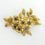 18ct gold sapphire set floral design brooch, London 1989, 16 grams. 54 x 38 mm. UK Postage £12.