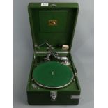 H.M.V green cased table top wind-up gramophone, retailed by Harods, with some 78's. UK Postage £20.