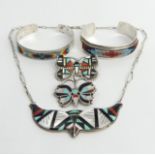 Five items of Native American silver jewellery, viz. two brooch/pendants, two bangles and a