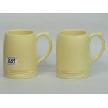 Two Wedgwood Keith Murray straw colour pottery tankards. 12 cm high. UK Postage £14.