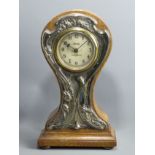 Edwardian oak balloon form clock with a decorative silver? mount. 33cm high x 19 cm wide.
