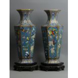 Afine pair of Chinese cloisonne enamel vases on carved and pierced hardwood stands. 35 cm. UK