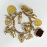 9ct gold curb link charm bracelet with a spade guinea and 1/2 sovereign, 67 grams. UK Postage £12.