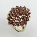 9ct gold garnet cluster ring, 4.8 grams, size N, 23.2 mm. UK Postage £12.