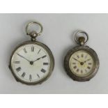 A silver key wind pocket watch and a fancy dial silver pocket watch. Largest 58 x 40 mm. UK