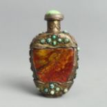 A Chinese stone snuff bottle with turquoise set metal mounts. 88 mm. UK Postage £12.