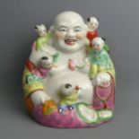 A large Chinese porcelain figure of Buddha, 28 cm. UK Postage £18.