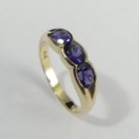 9ct gold purple three stone ring, London 2001, 2.4 grams. Size M, 4.95 mm. UK Postage £12.