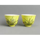 A pair of Chinese yellow ground porcelain tea bowls, both with six character marks. 53 x 68 mm. UK