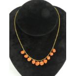 15ct gold and carved coral necklace, 12 grams. 40 cm. UK Postage £12.