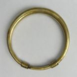 A Chinese polished bronze bangle with seal mark. 52 grams. UK Postage £12.