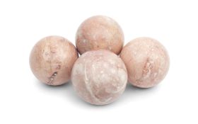 A SET OF FOUR DECORATIVE PINK MARBLE SPHERES